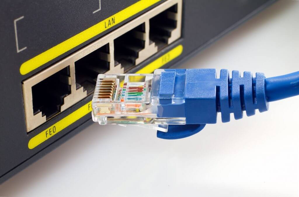 Plugging an ethernet cable into a router