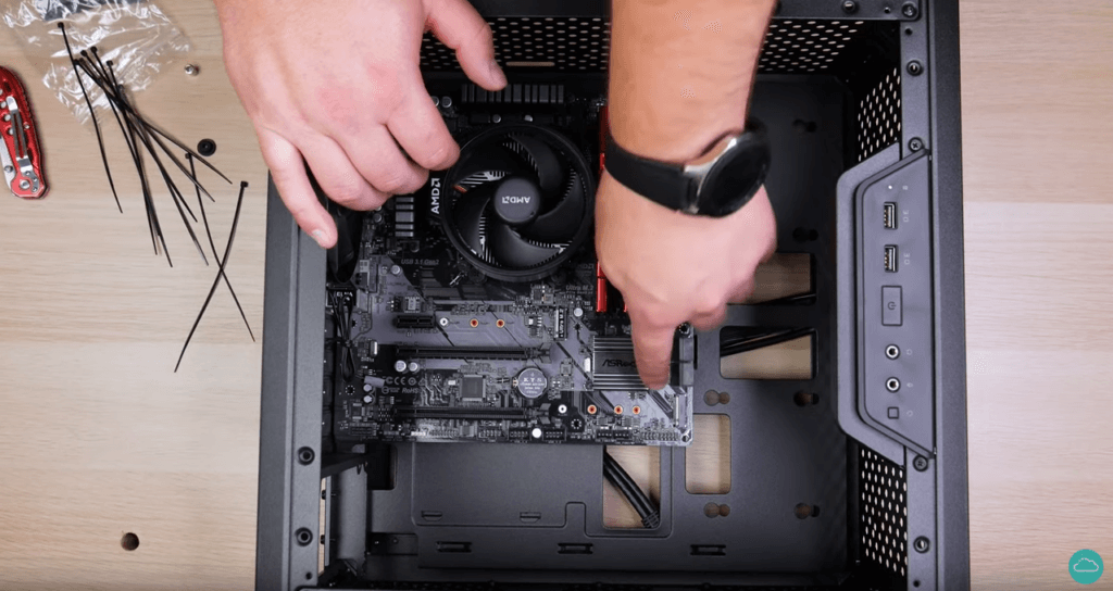 A technician placing a motherboard into a case