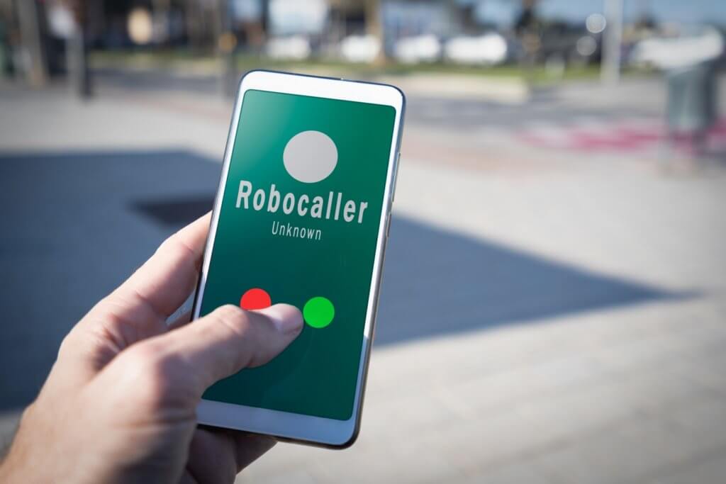 Smartphone showing on screen an illegal robocall. Smartphone showing a call from a robocaller on screen