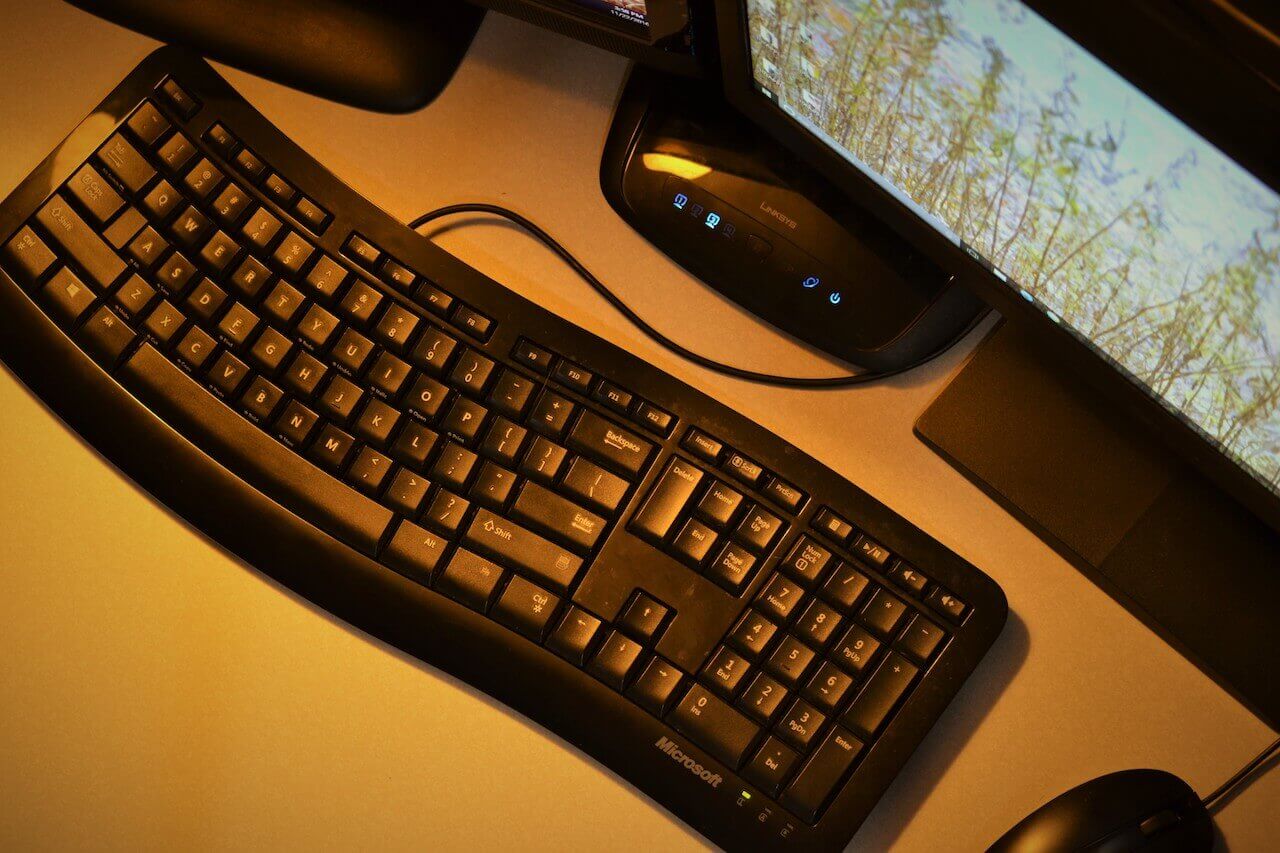 Black desktop computer and keyboard