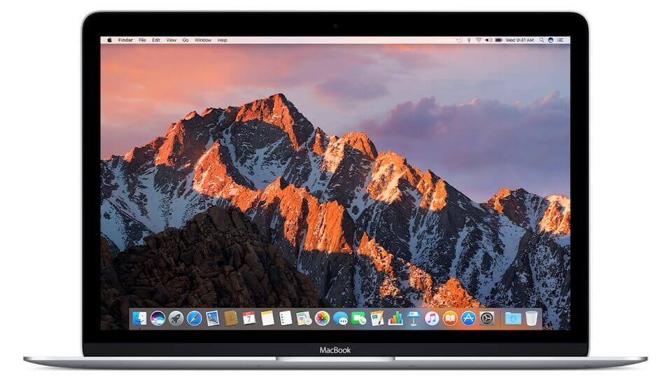 A picture of a Macbook with a mountain at sunset as the background